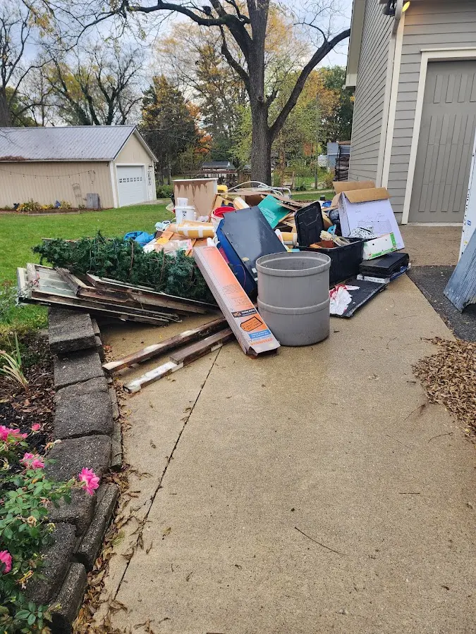 Dumpster being loaded with debris for Estate Cleanout Dumpster Rental in Garden City